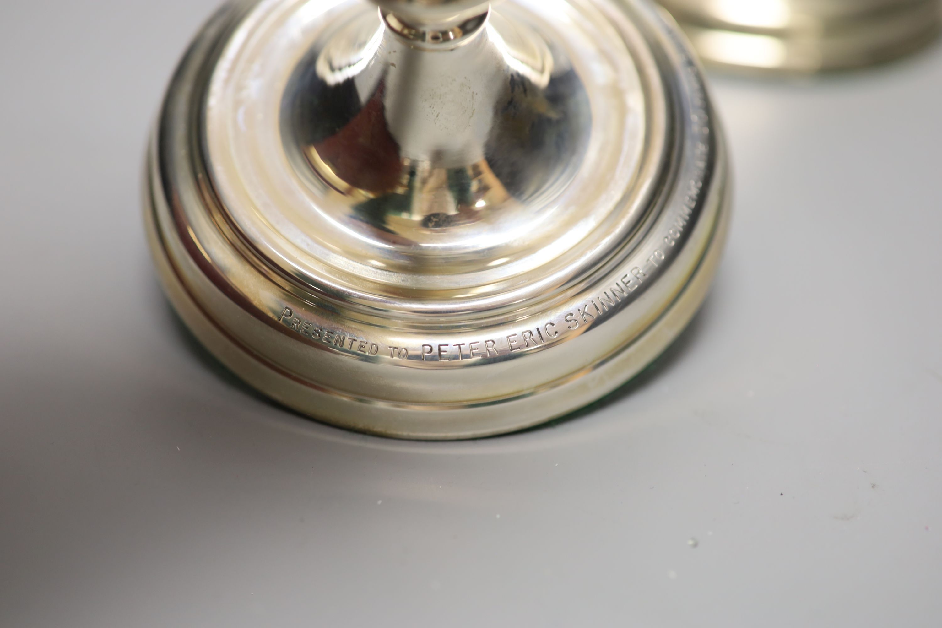 A pair of George II style silver presentation candlesticks, weighted, London 1986, David Shaw Silverware Ltd, in fitted case